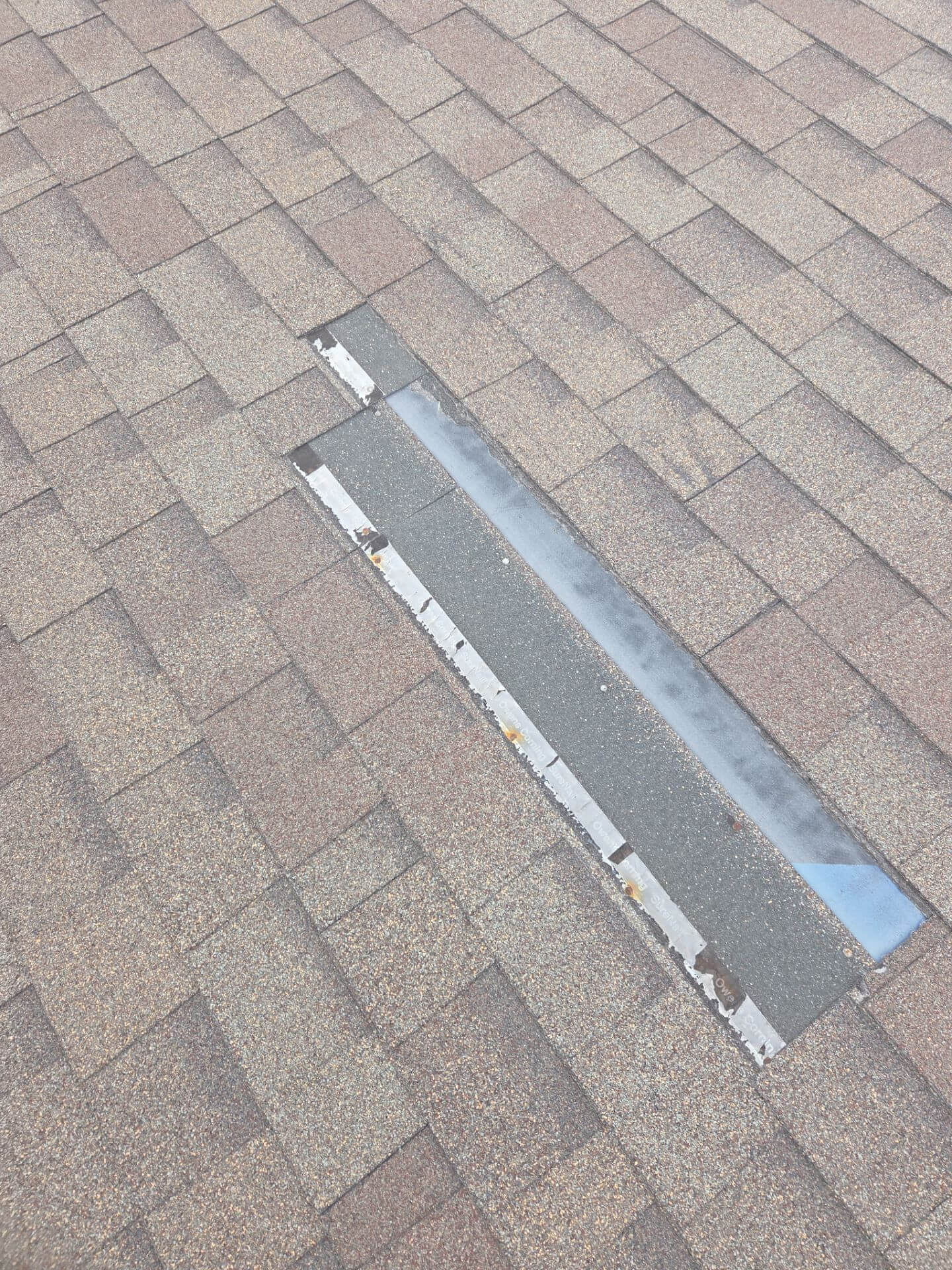 Before image of residential roof showing damaged shingles and signs of wear prior to roofing work by Wegner Roofing Before image of residential roof showing damaged shingles and signs of wear prior to roofing work by Wegner Roofing